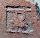 Auxiliary Units
Specialized Military Brick Manufacturers

TRA in ligature (stands for Transrhenana). This stamp is from the time of Nero, and gives reference to a unit making bricks on the "other" side of the river Rhine. The exact location is u